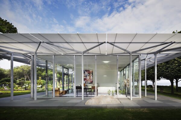 The dramatic roof overhang creates a partially covered, wraparound patio.