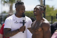 Former Miami Dolphins wide receiver Brandon Marshall, left, speaks to Iowa wide receiver Brandon Smith after competition in the vertical jump at a mini combine organized by House of Athlete, Friday, March 5, 2021, in Fort Lauderdale, Fla. (AP Photo/Marta Lavandier)