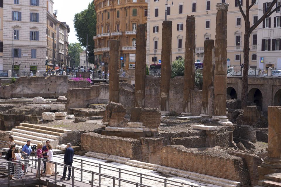 Journalists visit the new walkways of the so called 'Sacred Area' where four temples, dating back as far as the 3rd century B.C., stand smack in the middle of one of modern Rome's busiest crossroads, Monday, June 19, 2023, With the help of funding from Bulgari, the luxury jeweler, the grouping of temples can now be visited by the public that for decades had to gaze down from the bustling sidewalks rimming Largo Argentina (Argentina Square) to admire the temples below where Julius Caesar masterminded his political strategies and was later fatally stabbed in 44 B.C. (AP Photo/Domenico Stinellis)