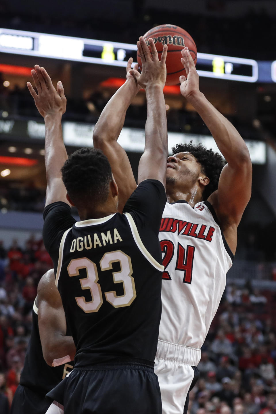 Louisville forward Dwayne Sutton (24) is fouled by Wake Forest forward Ody Oguama (33) during the second half of an NCAA college basketball game Wednesday, Feb. 5, 2020, in Louisville, Ky. Louisville won 86-76. (AP Photo/Wade Payne)