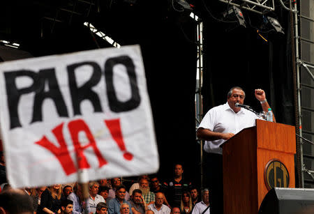Hector Daer, secretary general of Argentina's National General Confederation of Labor (CGT), addresses the crowd during a broad march in solidarity with striking teachers in Buenos Aires, Argentina March 7, 2017. The sign reads "Strike now." REUTERS/Martin Acosta