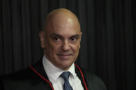 FILE - Judge Alexandre de Moraes stands as he is sworn in as the new head of the Supreme Electoral Tribunal, the government body that oversees elections, ahead of the Oct. 2 elections in Brasilia, Brazil, Aug. 16, 2022. De Moraes has been aggressively pursuing those suspected of undermining Brazil’s democracy, whether it's investigating former President Jair Bolsonaro, arresting protesters on slim evidence or banishing some people from social media after they were accused of spreading conspiracy theories. (AP Photo/Eraldo Peres, File)