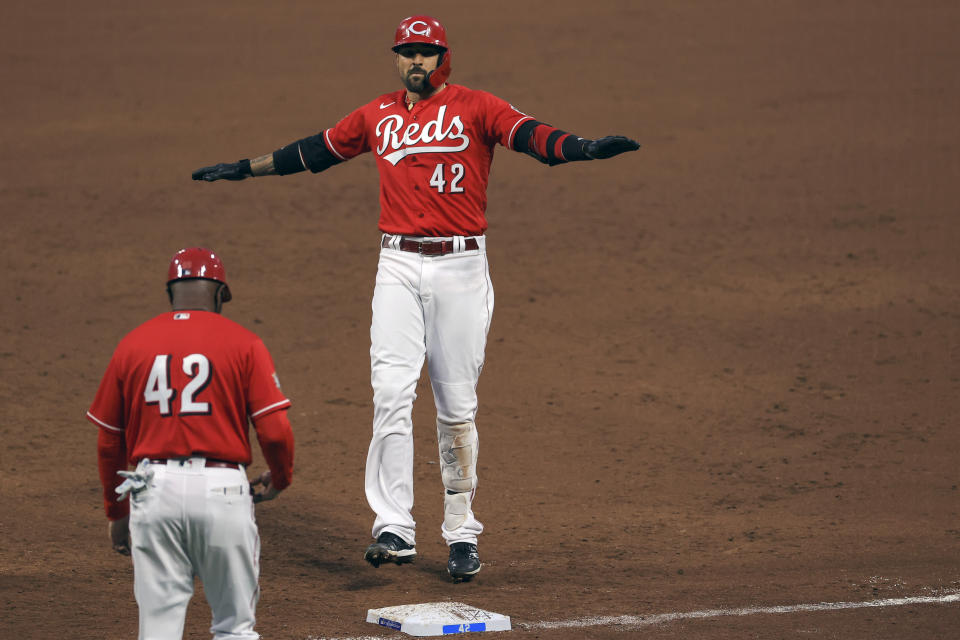 Cincinnati Reds' Nick Castellanos reacts to hitting an RBI single during the third inning of a baseball game against the Cleveland Indians in Cincinnati, Friday, April 16, 2021. (AP Photo/Aaron Doster)