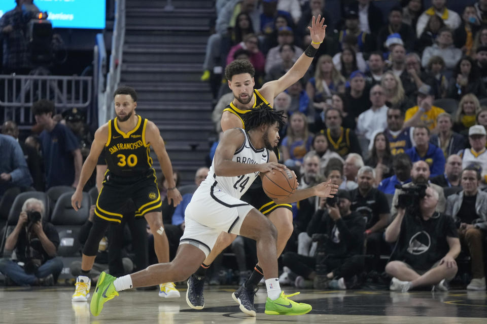 Brooklyn Nets guard Cam Thomas (24) drives to the basket against Golden State Warriors guard Klay Thompson during the first half of an NBA basketball game in San Francisco, Saturday, Dec. 16, 2023. (AP Photo/Jeff Chiu)