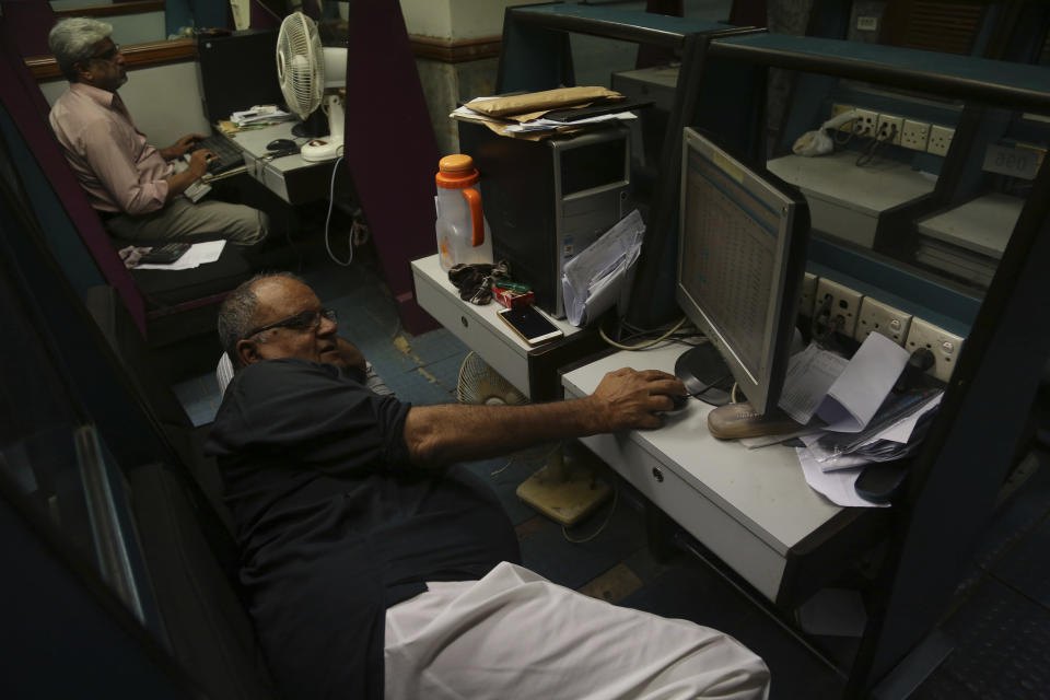 Pakistani brokers monitor stock market at Karachi Stock Exchange in Pakistan, Friday, Nov. 30, 2018. There were panic in the market and index fell sharply. Pakistan's currency has plunged further as the country is mired in a financial crisis and seeking an $8 billion bailout package from the International Monetary Fund. The Pakistani rupee was trading at 142 to the dollar on Friday, a decline from 133.90 rupees to $1 at close of business the previous day. (AP Photo/Shakil Adil)