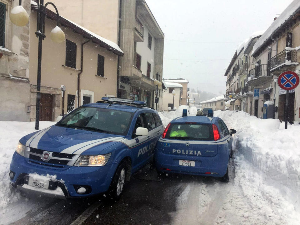 Two police cars make their way along the snow covered main road of Montereale, central Italy, Wednesday, Jan. 18, 2017. Montereale was the epicenter of three strong earthquakes that shook central Italy in the space of an hour Wednesday, striking the same region that suffered a series of deadly quakes last year and further isolating towns that have been buried under more than a meter (three feet) of snow for days. (Claudio Lattanzio/ANSA via AP)