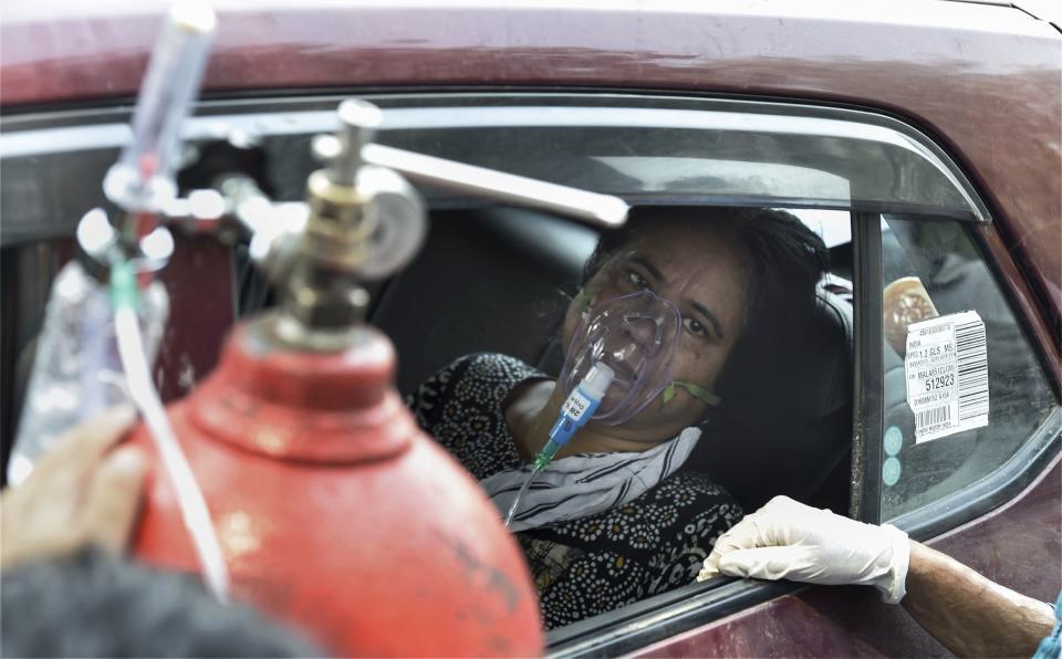 New Delhi: A COVID-19 patient waits outside the LNJP hospital in New Delhi on Sunday.