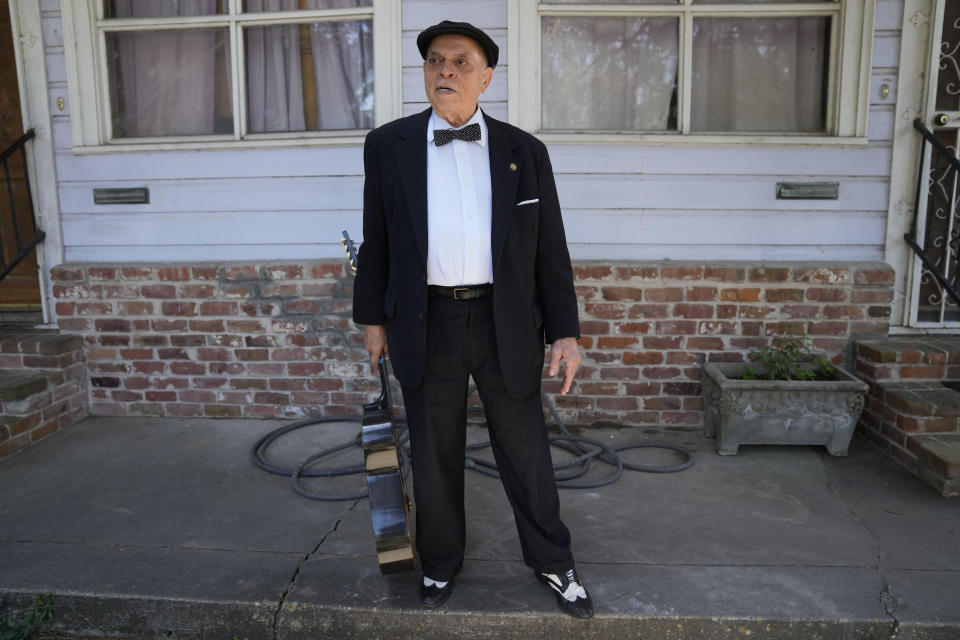 Guitarist and singer Deacon John Moore stands outside his home in New Orleans, Wednesday, May 3, 2023. Moore has been a regular performer at the New Orleans Jazz & Heritage Festival since it began in 1970, and is playing the festival again this year. (AP Photo/Gerald Herbert)