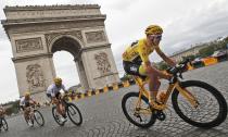 Four-time Tour de France winner Chris Froome passes the Arc de Triomphe on the Champs Élysées in Paris during the final stage of the race.