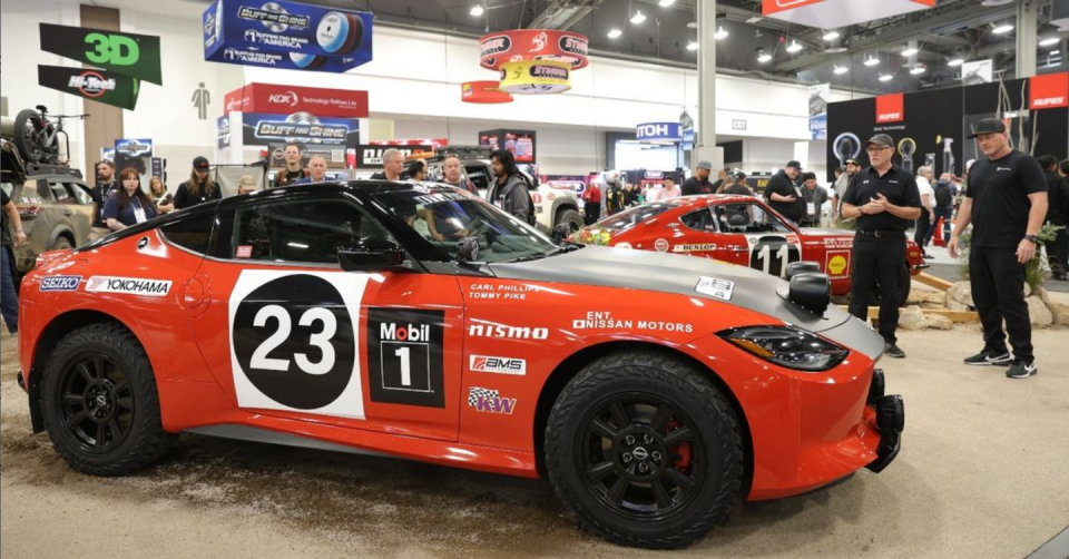 a group of people around a race car