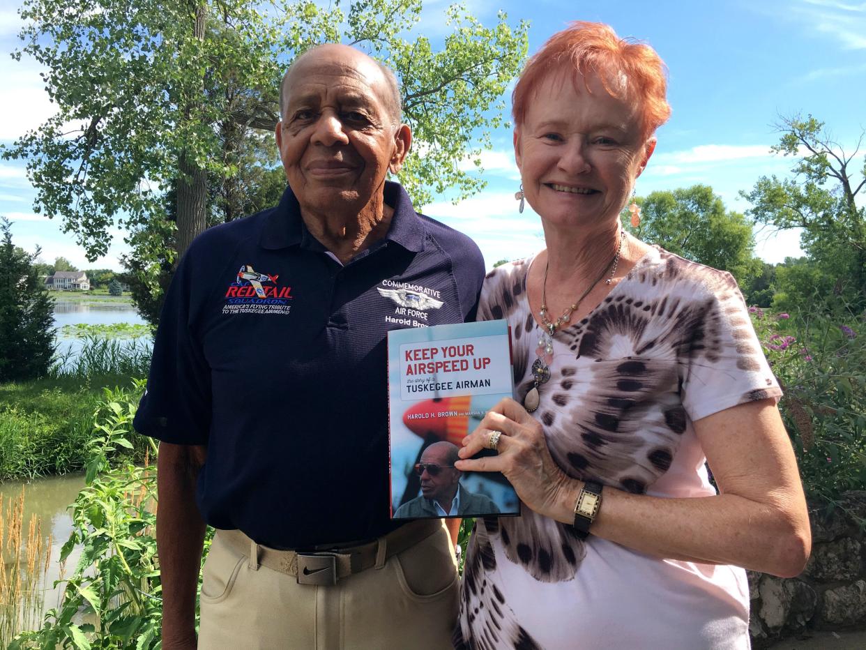 In this June 2019 photo, Marsha Bordner holds up a copy of "Keep Your Airspeed Up," a book she co-authored with her husband, Harold Brown, about his life and experiences during World War II as a Tuskegee Airman.