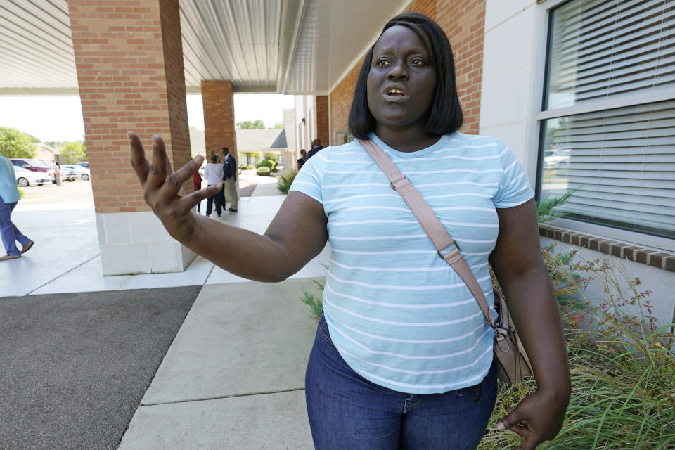 Deneka Samuel of Jackson, Miss., cannot hide her disappointment and frustration at the problems with the city's water system, Sept. 7, 2022, as she stands in the parking lot of Mt. Nebo Baptist Church, during a meeting of some African American community leaders with Environmental Protection Agency administrator Michael S. Regan, U.S. Rep. Bennie Thompson, D-Miss., and Mayor Chokwe Antar Lumumba. The meeting held in the church's small sanctuary kept a number of community leaders standing outside the room as they discussed the longstanding problems with the two water-treatment plants and its infrastructure. (AP Photo/Rogelio V. Solis)