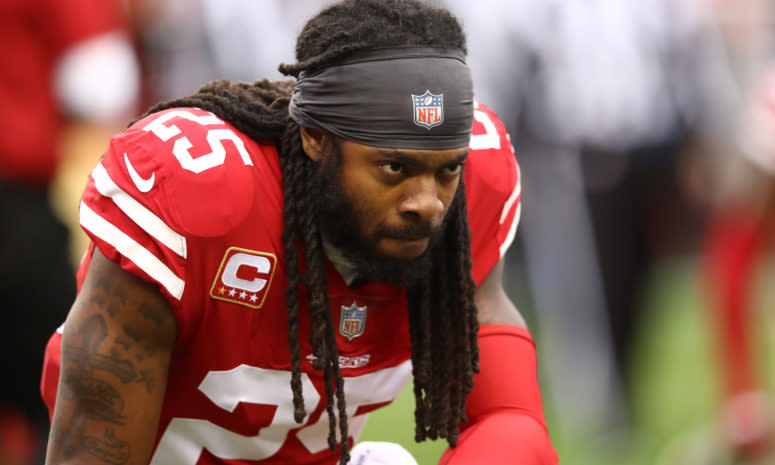 Richard Sherman takes a knee during a game for the San Francisco 49ers.