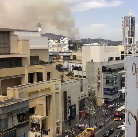 Smoke rises in the distance as seen from the front of the Dolby Theatre during a brush fire near the Giffith Observatory in Los Angeles, United States, in this still image taken from a July 10, 2018 video footage by Myke Wilson obtained from social media. Myke Wilson/Social Media/via REUTERS