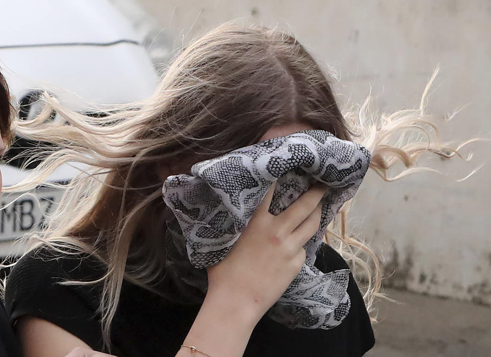 A 19 year-old British woman, that was found guilty of making up claims she was raped by up to 12 Israelis, arrives at Famagusta District Court with her mother for sentencing on Tuesday, Jan. 7, 2020. A Cyprus court handed a four-month suspended sentence to a 19-year-old British woman who was found guilty of public mischief for making up claims that she was raped by up to a dozen Israelis. (AP Photo/Petros Karadjias)