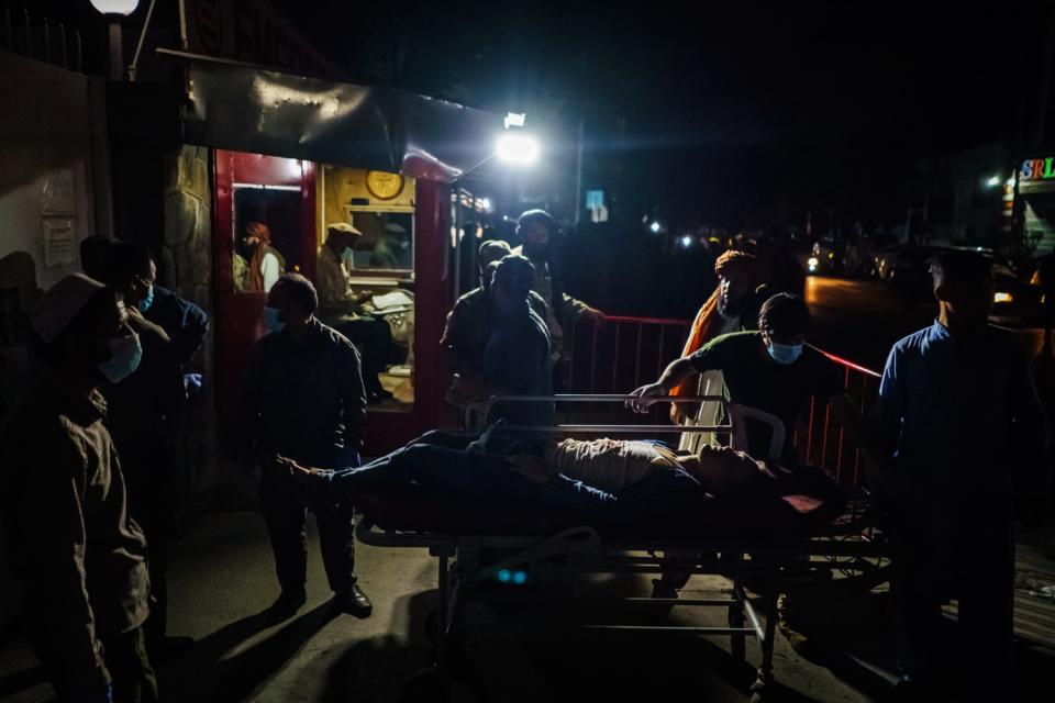 Medical workers attend to a patient.