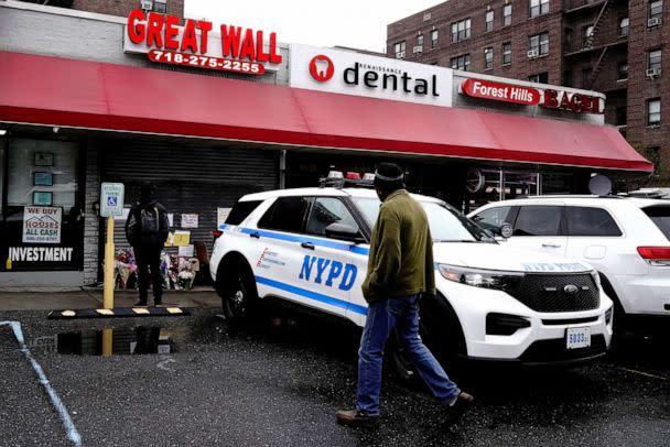 A NYPD patrol vehicle stands outside a memorial for Zhiwen Yan, a 45 year old Chinese immigrant fatally shot and killed on April 30, at Great Wall, a Chinese restaurant where he worked, in the Forest Hills neighborhood of Queens, New York, May 2, 2022. (Bing Guan/Reuters)