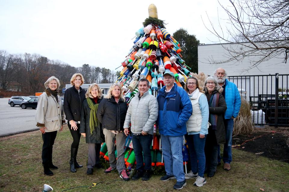 Fuel and More board members, organizer Kelly Philbrook and Kittery Ace Hardware store co-owner Ernie D'Angelo (center), gather at this year's buoy tree Tuesday, Dec. 6, 2022 at the Ace Hardware store in Kittery, Maine.