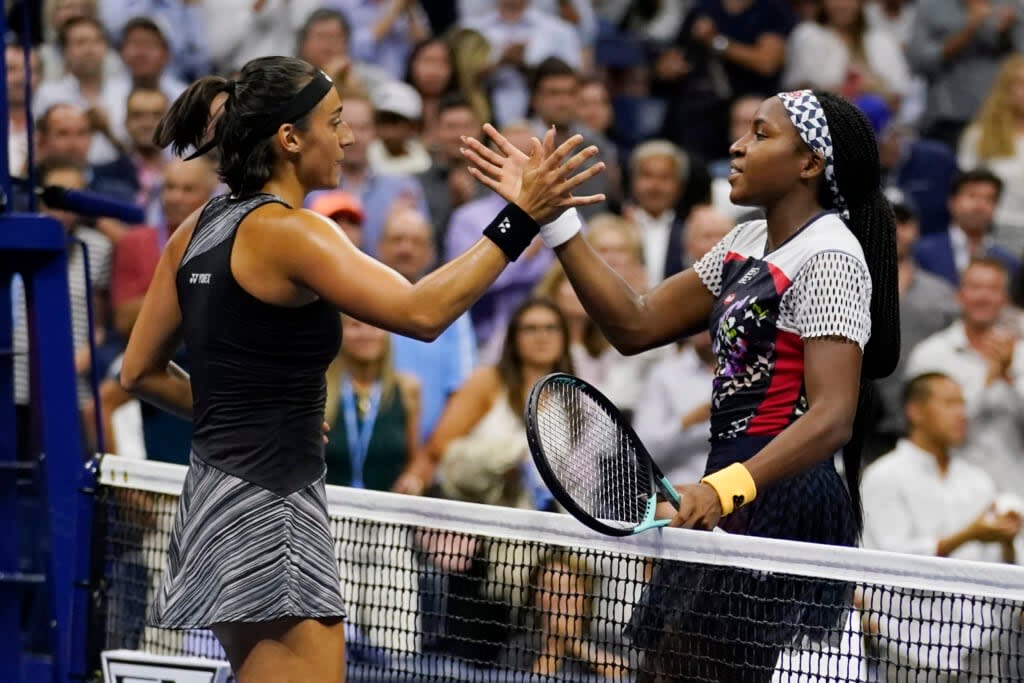 Caroline Garcia, of France, left, shakes hands with Coco Gauff after a quarterfinal of the U.S. Open tennis championships, Tuesday, Sept. 6, 2022, in New York. Garcia won the match. (AP Photo/Charles Krupa)