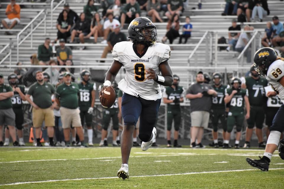 Mooresville's Nick Patterson rolls out for a pass during the Pioneers' scrimmage with Pendleton Heights on Aug. 12, 2022.