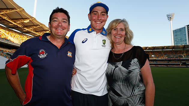 Matthew and his parents celebrate at the Gabba. Image: Getty