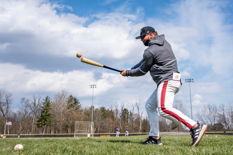 Warren Central High School baseball head coach Chris Urey hits ground balls during practice Wednesday, March 29, 2023, at their home field in Indianapolis. 