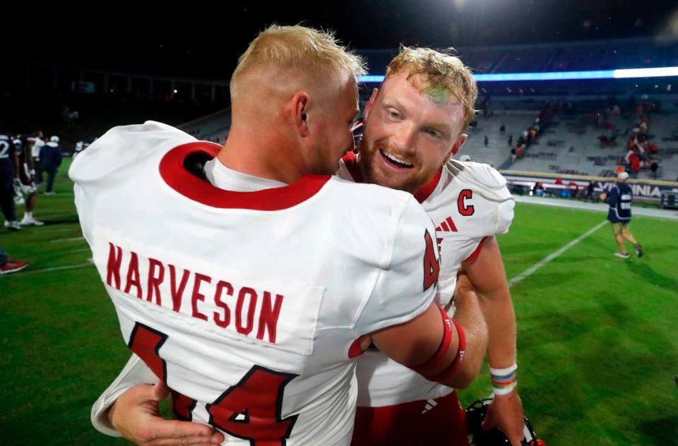 N.C. State kicker Brayden Narveson (44) celebrates with quarterback Brennan Armstrong (5) after the Wolfpack’s 24-21 victory over Virginia at Scott Stadium in Charlottesville, Va., Friday, Sept. 22, 2023.