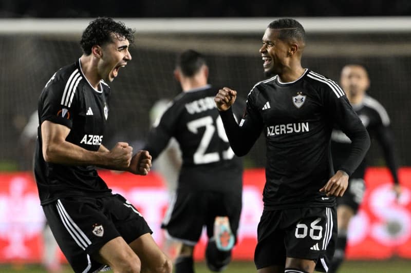 Agdam's Bahlul Mustafazade (L) and Patrick Andrade celebrate their side's second goal during the UEFA Europa League round of 16 first leg soccer match between FK Karabakh Agdam and Bayer Leverkusen at Tofiq Bahramov Stadium. Federico Gambarini/dpa