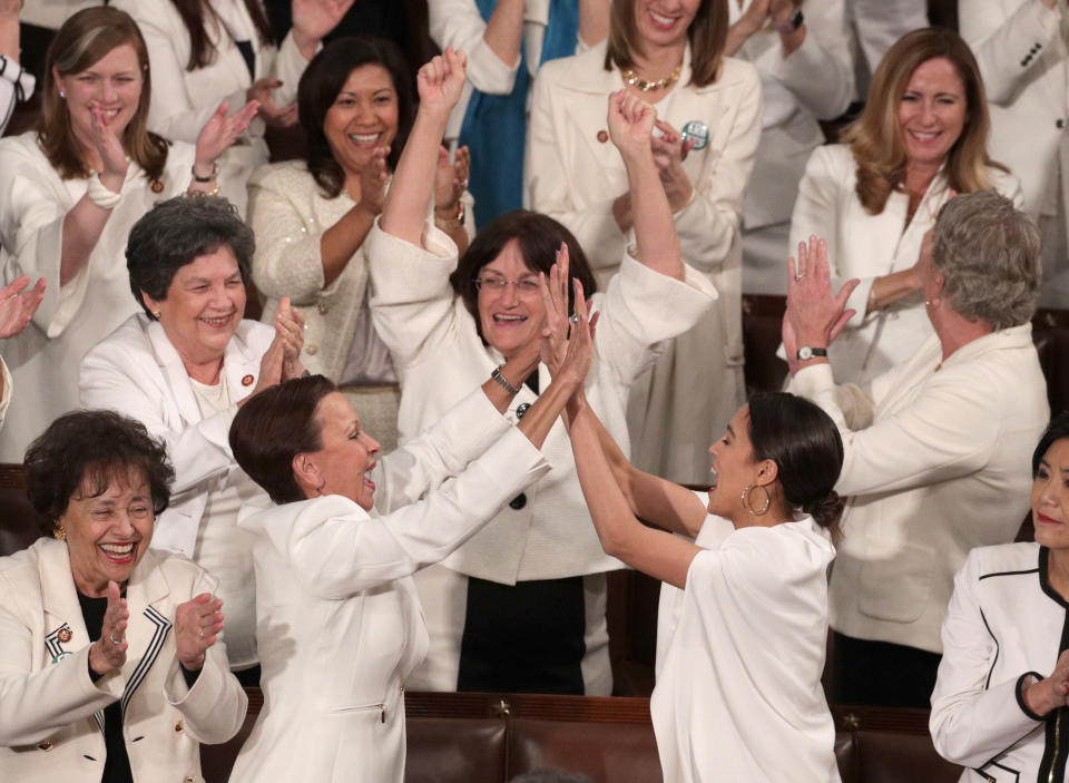 WASHINGTON, DC - FEBRUARY 05: Rep. Alexandria Ocasio-Cortez (D-NY) and other female lawmakers cheer during President Donald Trump's State of the Union address in the chamber of the U.S. House of Representatives at the U.S. Capitol Building on February 5, 2019 in Washington, DC. A group of female Democratic lawmakers chose to wear white to the speech in solidarity with women and a nod to the suffragette movement. (Photo by Alex Wong/Getty Images)