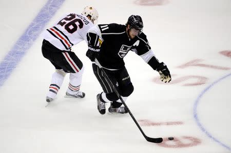 May 24, 2014; Los Angeles, CA, USA; Los Angeles Kings center Anze Kopitar (11) controls the puck against Chicago Blackhawks center Michal Handzus (26) during the second period in game three of the Western Conference Final of the 2014 Stanley Cup Playoffs at Staples Center. Mandatory Credit: Richard Mackson-USA TODAY Sports