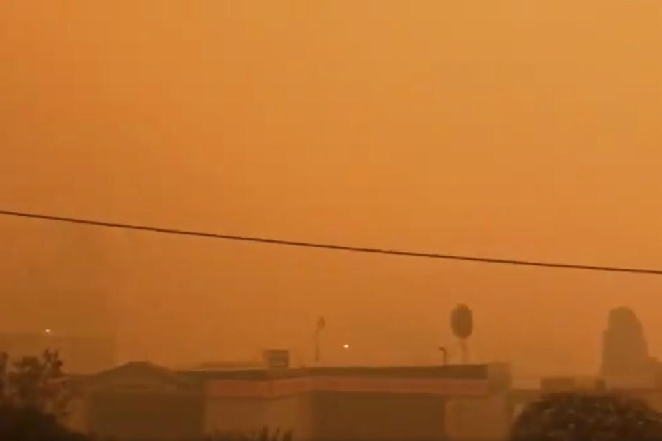 In this Tuesday, Dec. 31, 2019, image from video, smoke from wildfires covers Batehaven, near Batemans Bay, New South Wales, Australia. Thousands of tourists fled Australia's wildfire-ravaged eastern coast Thursday, Jan. 2, 2020, ahead of worsening conditions as the military started to evacuate people trapped on the shore further south. (Josh Aldwell via AP)