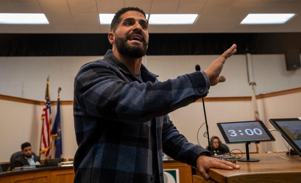 Dearborn resident Hassan Chami speaks with community members during a Dearborn Board of Education meeting Monday, Oct. 10, 2022.