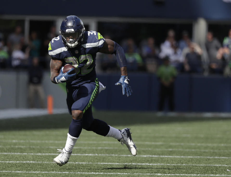 FILE - In this Sept. 23, 2018, file photo, Seattle Seahawks running back Chris Carson carries against the Dallas Cowboys during the first half of an NFL football game in Seattle. The Seahawks, who play the Oakland Raiders this week in London, have seen a running back rush for 100 yards in three straight games for the first time since late in the 2012 season. Carson had 100-yard games against Dallas and Los Angeles, and Mike Davis had 101 yards against Arizona. (AP Photo/Elaine Thompson, File)