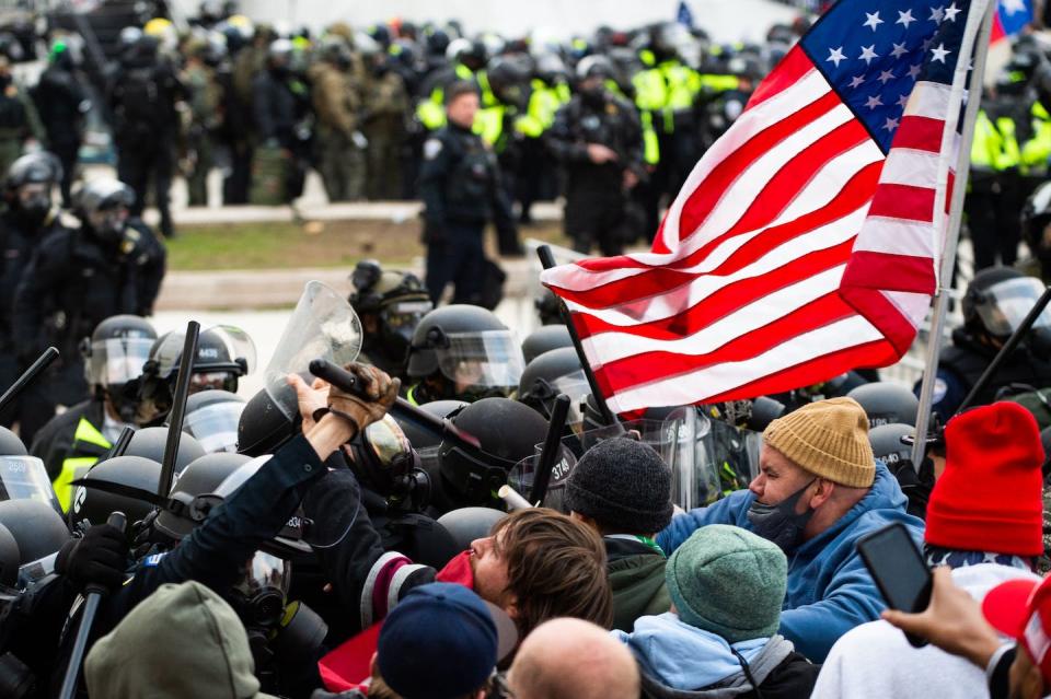 Rioters outside the U.S. Capitol Building on Jan. 6, 2021, clash with police. <a href="https://media.gettyimages.com/photos/supporters-of-us-president-donald-trump-fight-with-riot-police-the-picture-id1230457933?s=612x612" rel="nofollow noopener" target="_blank" data-ylk="slk:Roberto Schmidt/AFP via Getty Images;elm:context_link;itc:0;sec:content-canvas" class="link ">Roberto Schmidt/AFP via Getty Images</a>