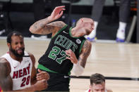 Boston Celtics' Daniel Theis (27) recoils from contact with Miami Heat's Andre Iguodala (28) during the second half of an NBA conference final playoff basketball game Friday, Sept. 25, 2020, in Lake Buena Vista, Fla. (AP Photo/Mark J. Terrill)