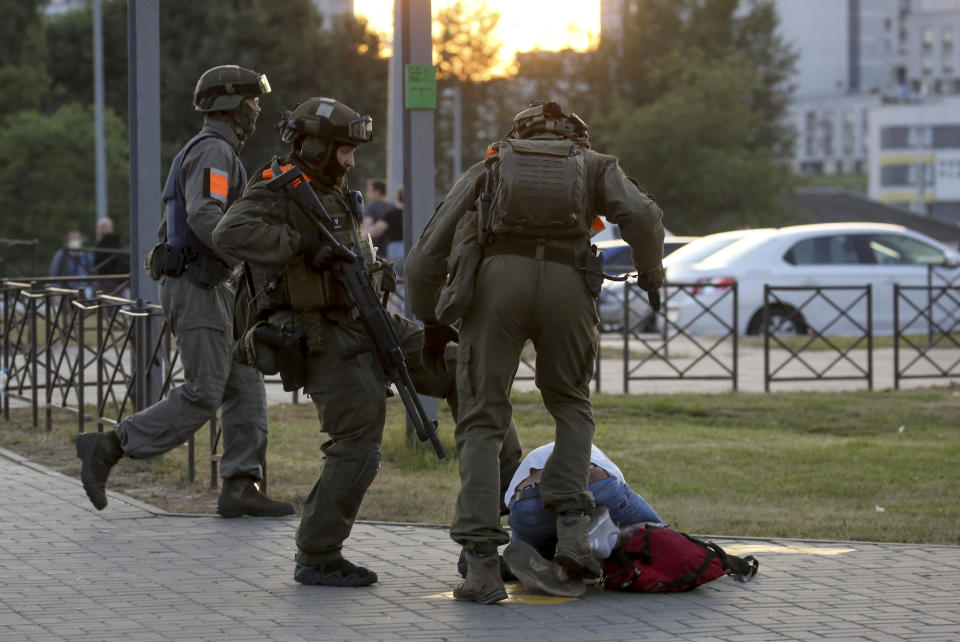 FILE - Police officers kick a demonstrator during a mass protest following presidential election in Minsk, Belarus, on Monday, Aug. 10, 2020. For most of his 27 years as the authoritarian president of Belarus, Alexander Lukashenko has disdained democratic norms, making his country a pariah in the West and bringing him the sobriquet of “Europe’s last dictator." Now, his belligerence is directly affecting Europe. (AP Photo, File)