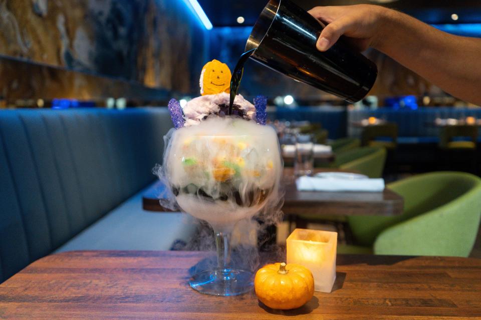 The Witch's Potion with Tito's vodka, black pineapple syrup, Sprite, a spooky assortment of sweets and cotton candy, from The Loaded Spoon in Freehold.