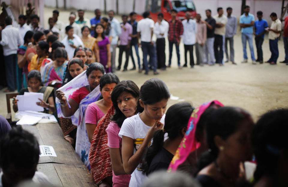 Indian voters wait in queues to cast their votes during the first phase of elections in Dibrugarh, in the northeastern state of Assam, India, Monday, April 7, 2014. (AP Photo/Altaf Qadri)