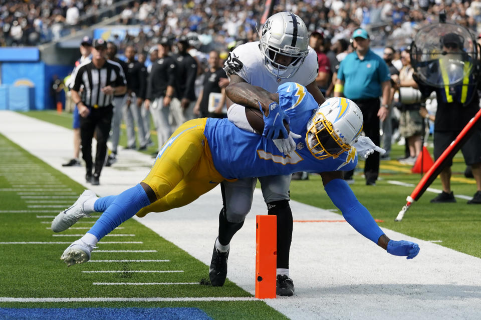 Los Angeles Chargers tight end Gerald Everett, bottom, scores a touchdown against Las Vegas Raiders safety Roderic Teamer during the second half of an NFL football game in Inglewood, Calif., Sunday, Sept. 11, 2022. (AP Photo/Gregory Bull)