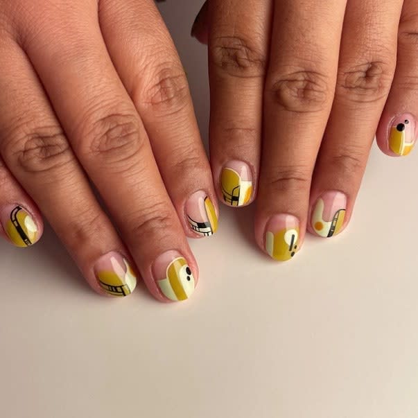 Treat your nails like tiny canvases and layer on a mix of colors and abstract patterns. To keep things from looking too busy, make sure to keep your polish shades in the same color family.