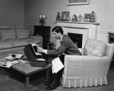 <p>Prince Charles sorts through papers on a cushioned armchair in his private salon.</p>