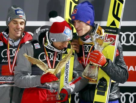 Ski Jumping - 65th four-hills ski jumping tournament final round - Bischofshofen, Austria - 06/01/2017 - Poland's Kamil Stoch, compatriot Piotr Zyla and Norway's Daniel Andre Tande pose on the podium after the final stage of the 65th four-hills tournament. REUTERS/Dominic Ebenbichler