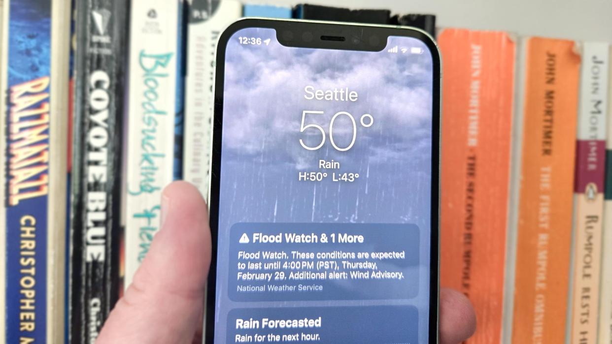  Weather app on an iPhone 12 running iOS 17 and showing a flood warning. 