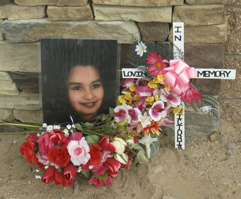 FILE - This Feb. 23, 2009 file photo shows a memorial for Victoria Chavez near the Southwest Mesa area where bodies have been discovered on the west side of Albuquerque, N.M. A decade ago, Albuquerque police began unearthing the remains of 11 women and an unborn child found buried on the city's West Mesa, marking the start of a massive homicide investigation that has yet to be resolved. On the 10th anniversary of the cold case, a small group of advocates and community members plan to gather Saturday, Feb. 2, 2019, near the 2009 crime scene to remember the victims and call for more protections for marginalized and vulnerable women in New Mexico's largest city. (Adolphe Pierre-Louis/Albuquerque Journal via AP, File)