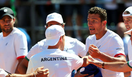 Tennis - Argentina v Italy - Davis Cup World Group First Round - Parque Sarmiento stadium, Buenos Aires, Argentina - 6/2/17. Argentina's player Diego Schwartzman (C) confronts Italy's sparring player Alessandro Giannessi after Italy's Fabio Fognini defeated Argentina's Guido Pella. REUTERS/Marcos Brindicci