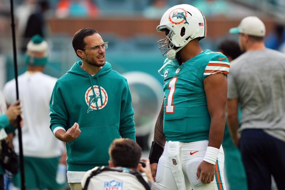 Dec 24, 2023; Miami Gardens, Florida, USA; Miami Dolphins head coach Mike McDaniel talks with quarterback Tua Tagovailoa (1) prior to the game against the Dallas Cowboys at Hard Rock Stadium. Mandatory Credit: Jasen Vinlove-USA TODAY Sports