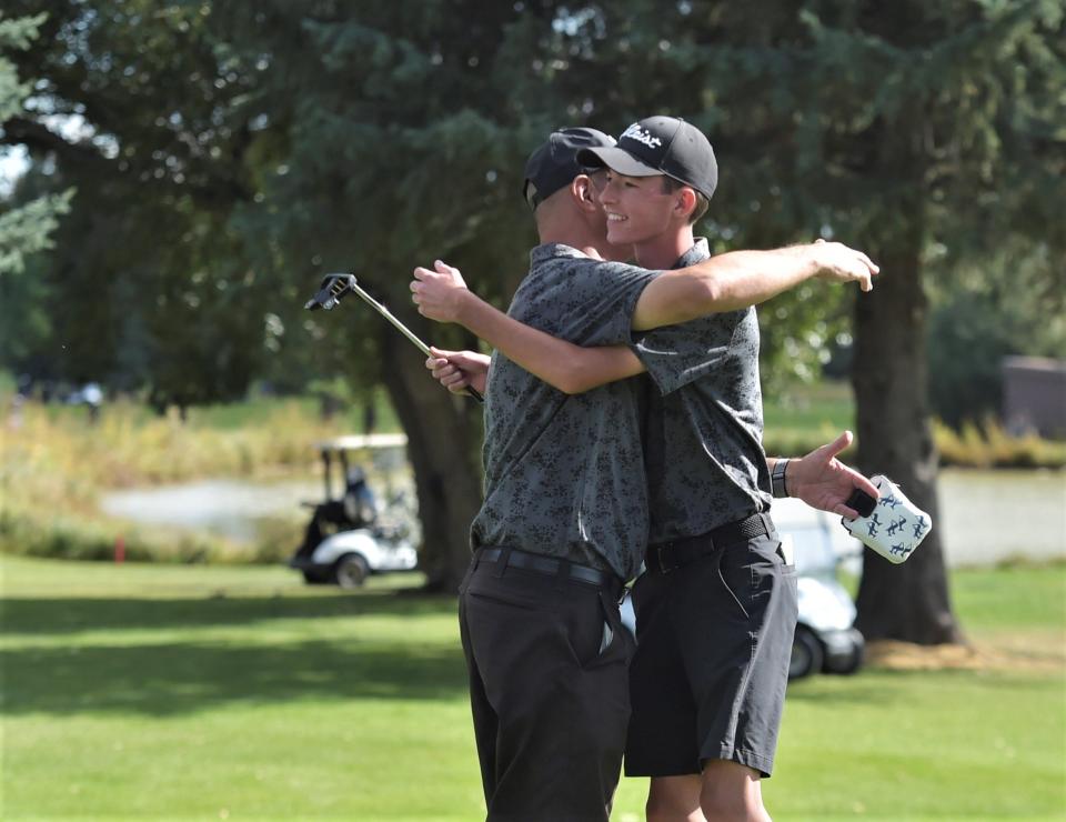 Fossil Ridge golfer Austin Barry hugs head coach Jamie Menefee after completing his round during the Colorado 5A boys golf state championships on Tuesday, Oct. 3, 2023 at Collindale Golf Course in Fort Collins, Colo.