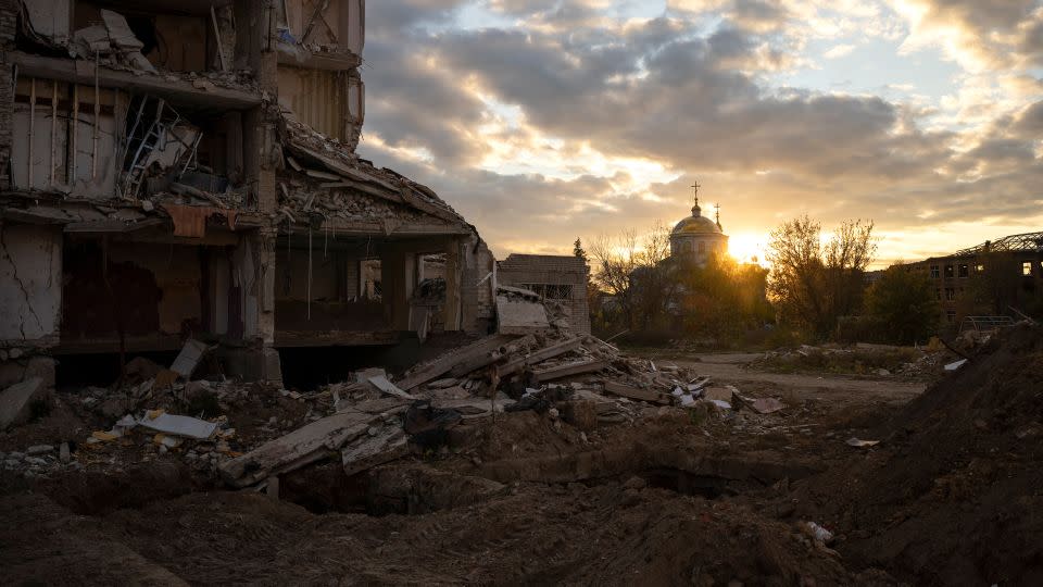 The sun sets over a destroyed building in Izyum, Ukraine. - Bram Janssen/AP