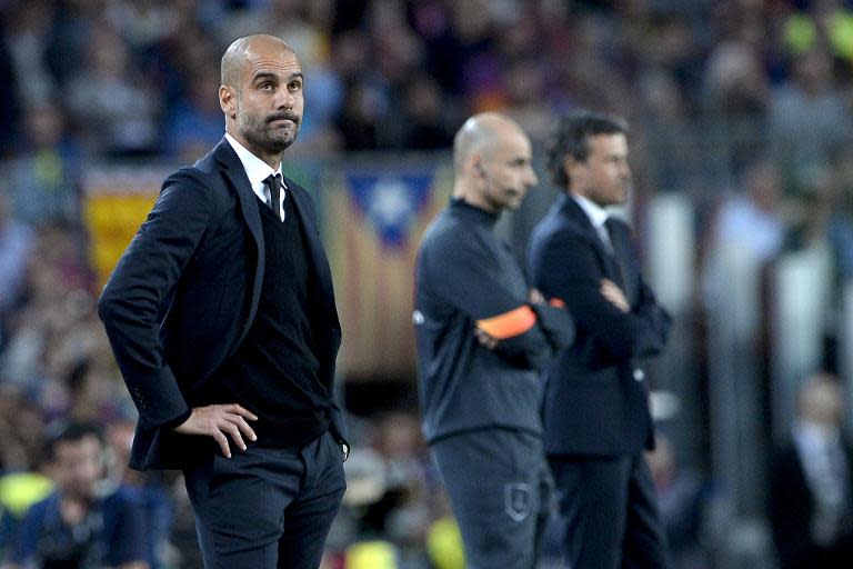 Bayern Munich coach Pep Guardiola (L) on the sidelines during his side's Champions League match against Barcelona at Camp Nou stadium on May 6, 2015