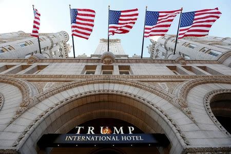 FILE PHOTO - Flags fly above the entrance to the new Trump International Hotel on its opening day in Washington, DC, U.S. on September 12, 2016. REUTERS/Kevin Lamarque/File Photo